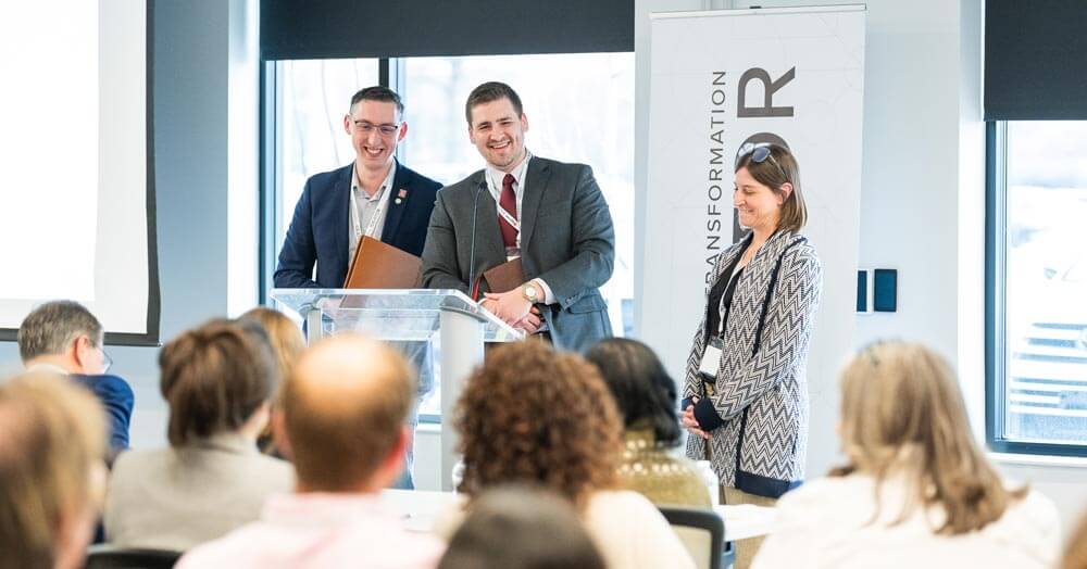 people at podium giving a presentation